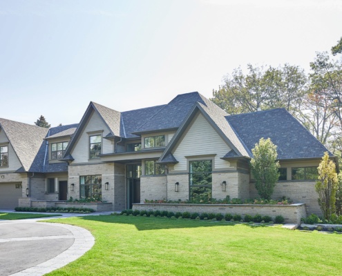 Toronto home with scones, stone planters and circular driveway.