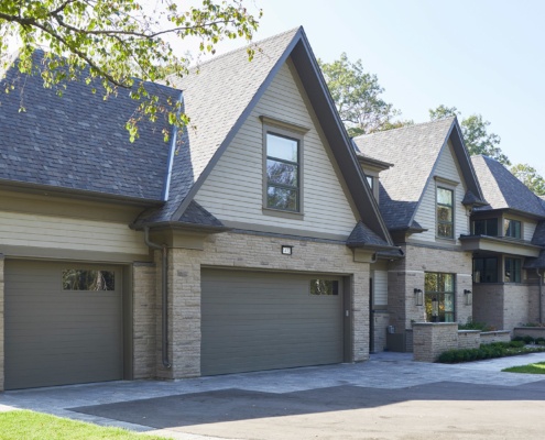 Transitional home with stone, wood siding and gables.