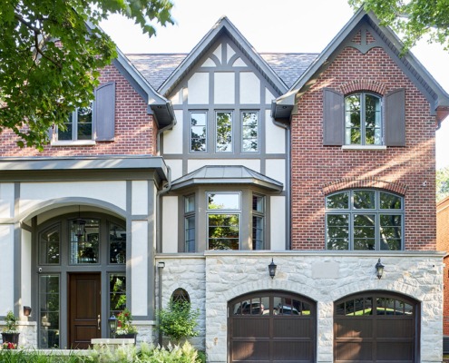 Toronto house with red brick, gray trim and white stucco.