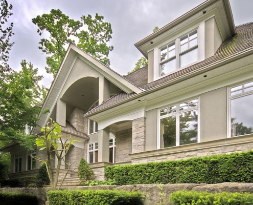 Mississauga house with stucco siding, natural stone and white trim.