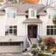 Mississauga home with grid windows, beige garage door and stone skirt.