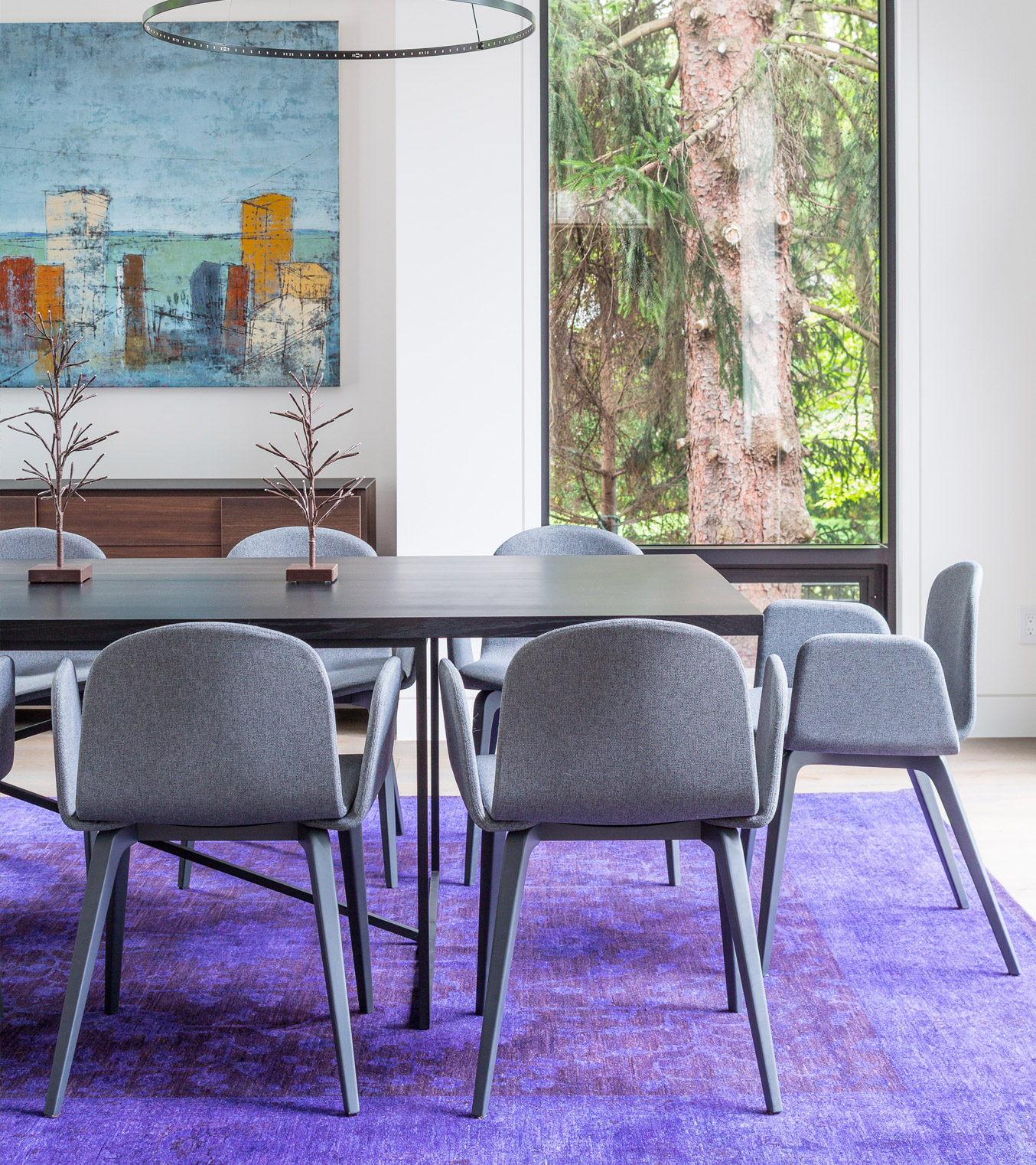 Elegant dining room with black frame window, wood table and purple carpet.