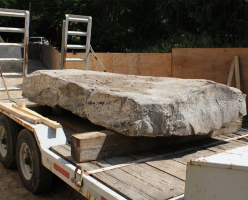 Big stone resting on trailer.