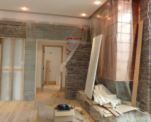 Construction of copper fireplace and stone wall.