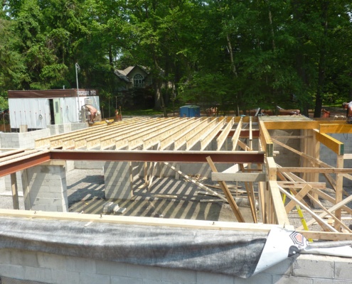 Construction workers installing floor joints for custom home.