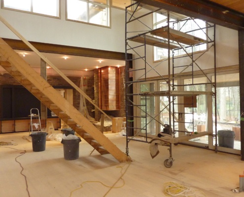 Construction with scaffolding and plywood stair for contemporary house.