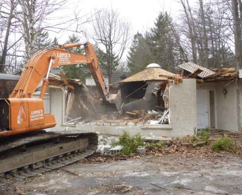 Bulldozer tearing down building.