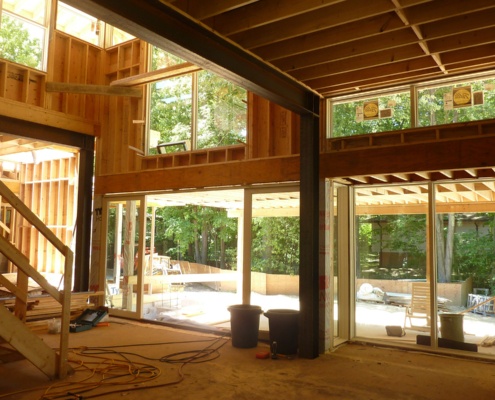Construction of kitchen with large windows.