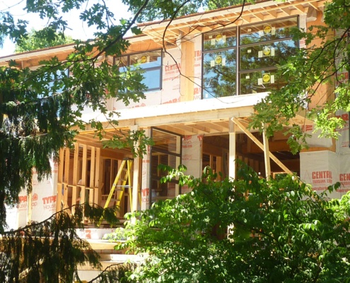 House construction with wood framing and large windows.